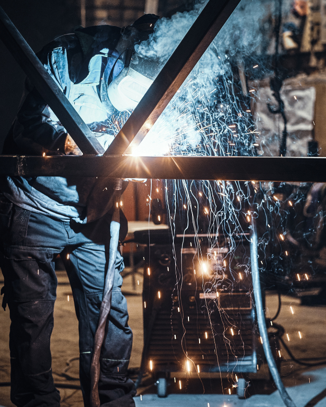 soldador soldando viga de hierro